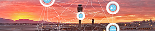 Panoramic view of an airport at sunset with the control tower centered. Overlaid network graphics connect various nodes with lines, featuring icons labeled '4G', 'LPWAN', and others, symbolizing wireless communication and network integration at the airport.